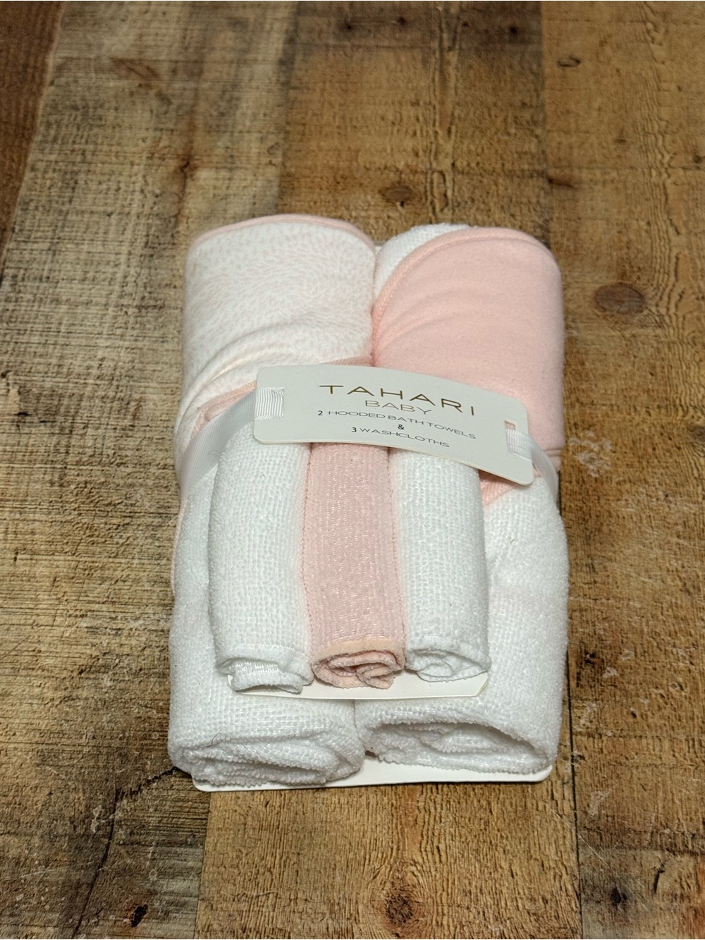 Tahari baby set new with tags 
Washcloths and towels 
Light pink - there is a ti
